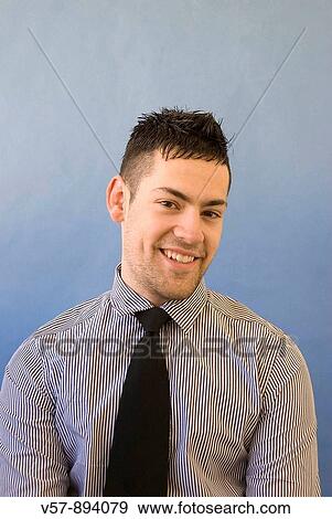 Stock Photo - Young man smiling and looking at the camera. Fotosearch