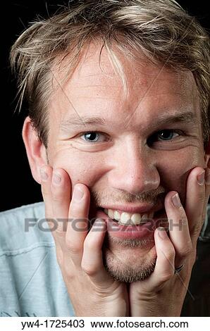 Stock Image - Young man smiling. Fotosearch