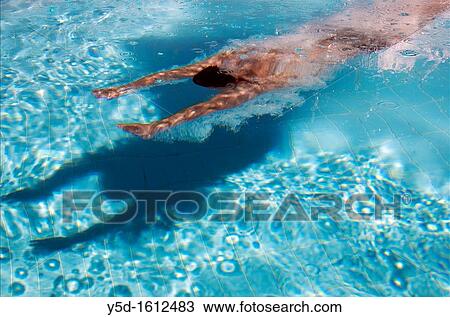 young man swimming under water in the swimming pool in companionship of his shadow View Large Photo Image Stock Image - young man swimming under water in the swimming pool in companionship of his shadow. Fotosearch
