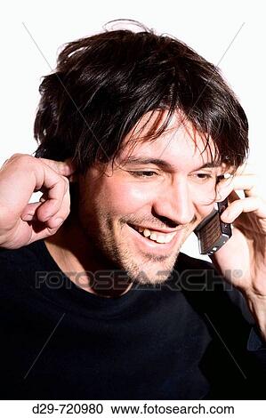Stock Image - Young man talking on cell phone. Fotosearch