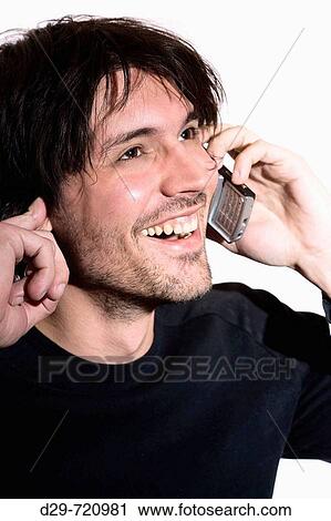 Stock Image - Young man talking on cell phone. Fotosearch