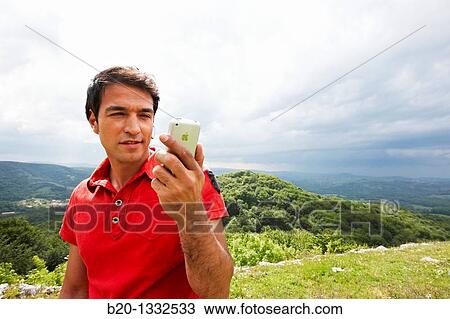 Young man using iPhone, Murguia, Alava, Euskadi, Spain View Large Photo Image Stock Image - Young man using iPhone, Murguia, Alava, Euskadi, Spain. Fotosearch