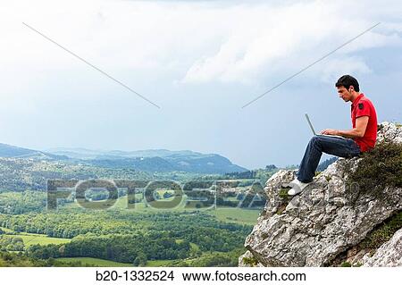 Young man using laptop computer, Murguia, Alava, Euskadi, Spain View Large Photo Image Picture - Young man using laptop computer, Murguia, Alava, Euskadi, Spain. Fotosearch