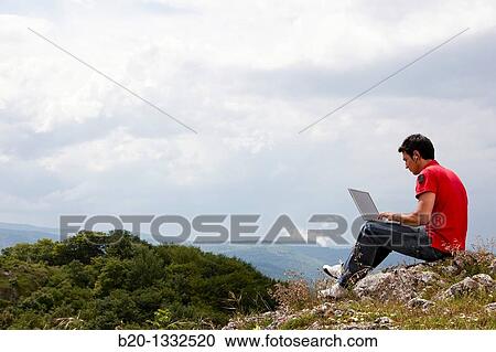 Stock Image - Young man using laptop computer, Murguia, Alava, Euskadi, Spain. Fotosearch