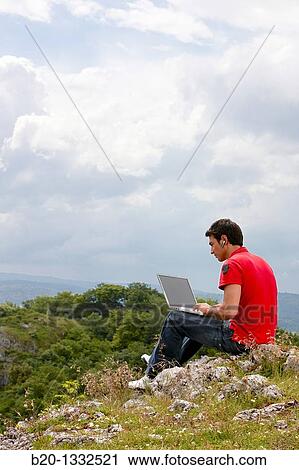 Young man using laptop computer, Murguia, Alava, Euskadi, Spain View Large Photo Image Stock Image - Young man using laptop computer, Murguia, Alava, Euskadi, Spain. Fotosearch
