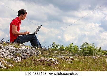 Young man using laptop computer, Murguia, Alava, Euskadi, Spain View Large Photo Image Stock Image - Young man using laptop computer, Murguia, Alava, Euskadi, Spain. Fotosearch