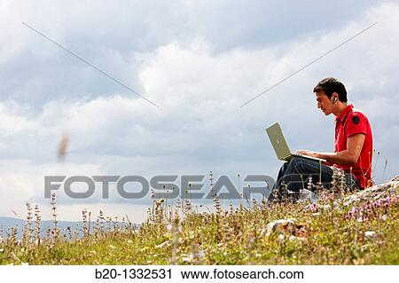 Young man using laptop computer, Murguia, Alava, Euskadi, Spain View Large Photo Image Stock Image - Young man using laptop computer, Murguia, Alava, Euskadi, Spain. Fotosearch