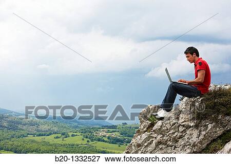 Young man using laptop computer, Murguia, Alava, Euskadi, Spain View Large Photo Image Stock Photo - Young man using laptop computer, Murguia, Alava, Euskadi, Spain. Fotosearch