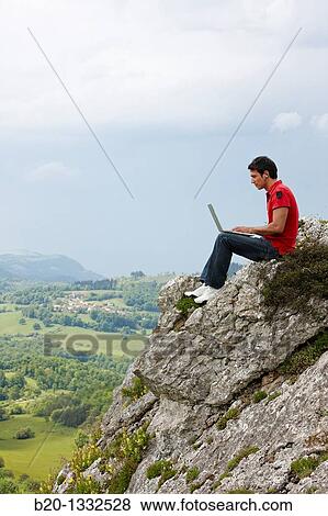 Young man using laptop computer, Murguia, Alava, Euskadi, Spain View Large Photo Image Stock Photo - Young man using laptop computer, Murguia, Alava, Euskadi, Spain. Fotosearch