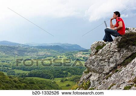 Stock Photograph - Young man using laptop computer, Murguia, Alava, Euskadi, Spain. Fotosearch