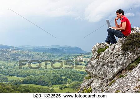 Young man using laptop computer, Murguia, Alava, Euskadi, Spain View Large Photo Image Stock Photography - Young man using laptop computer, Murguia, Alava, Euskadi, Spain. Fotosearch