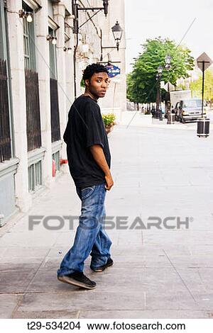 Young man walking in Montreal. Quebec. Canada. View Large Photo Image Picture - Young man walking in Montreal. Quebec. Canada.. Fotosearch