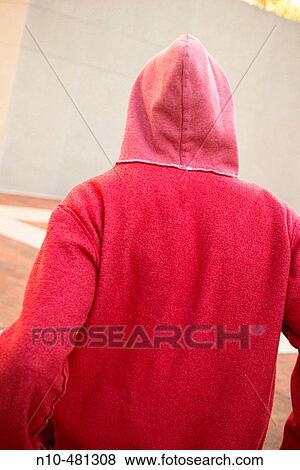 Young man, wearing a red sweatshirt, sitting on the ground View Large Photo Image Stock Photo - Young man, wearing a red sweatshirt, sitting on the ground. Fotosearch
