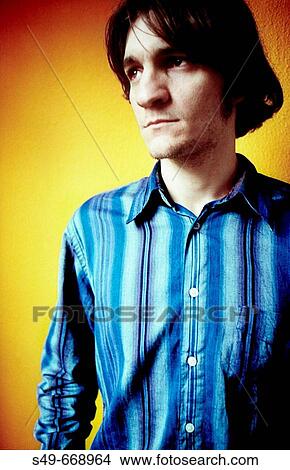 Young man wearing blue shirt View Large Photo Image Picture - Young man wearing blue shirt. Fotosearch