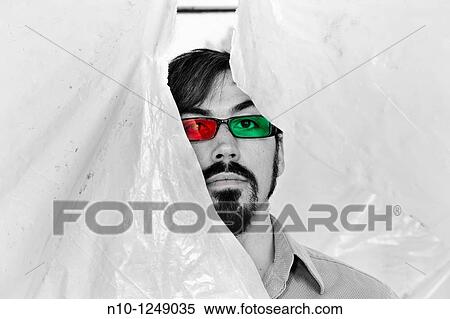 Young man wearing glasses with red and green lenses View Large Photo Image Stock Photography - Young man wearing glasses with red and green lenses. Fotosearch