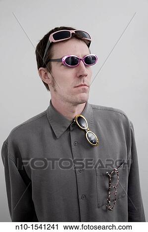 Young man wearing several pair of sunglasses View Large Photo Image Stock Image - Young man wearing several pair of sunglasses. Fotosearch