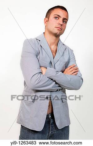 Stock Image - Young man wearing suit jacket and no shirt. Fotosearch