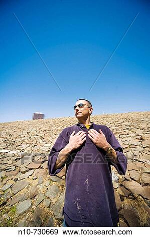 Young man, wearing sunglasses, posing. View Large Photo Image Stock Photo - Young man, wearing sunglasses, posing.. Fotosearch