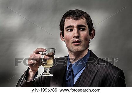 Young man with a glass of tea. View Large Photo Image Stock Photograph - Young man with a glass of tea.. Fotosearch