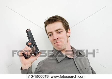Young man with a gun View Large Photo Image Stock Photograph - Young man with a gun. Fotosearch