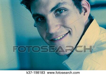 Stock Image - Young man with cute grin. Fotosearch