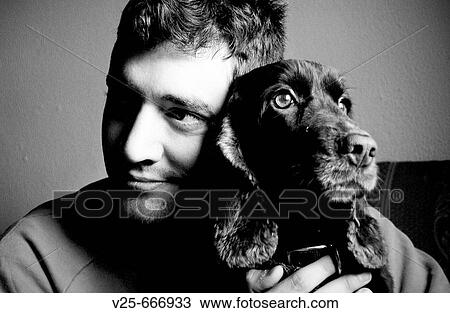 Stock Image - Young man with dog. Fotosearch
