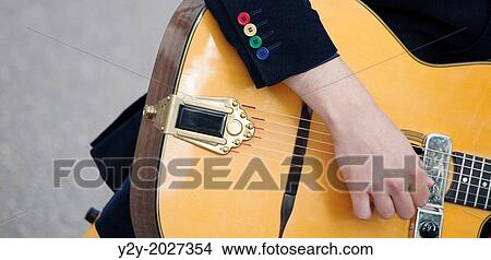 Young man with funny buttons playing guitar. View Large Photo Image Picture - Young man with funny buttons playing guitar.. Fotosearch