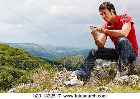 Stock Photo - Young man with iPhone, Murguia, Alava, Euskadi, Spain. Fotosearch
