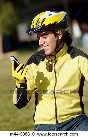 Young man with mobile phone on the bike. Valencia. Espaa View Large Photo Image Stock Image - Young man with mobile phone on the bike. Valencia. Espaa. Fotosearch