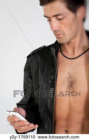 Stock Image - Young man with mobile phone. Fotosearch