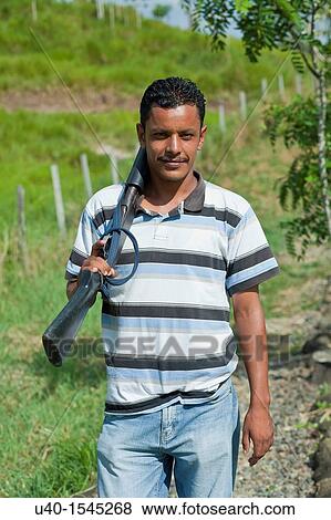 Stock Photo - Young man with shotgun. Fotosearch