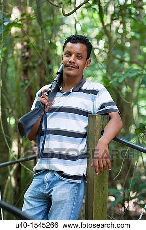 Stock Photograph - Young man with shotgun. Fotosearch