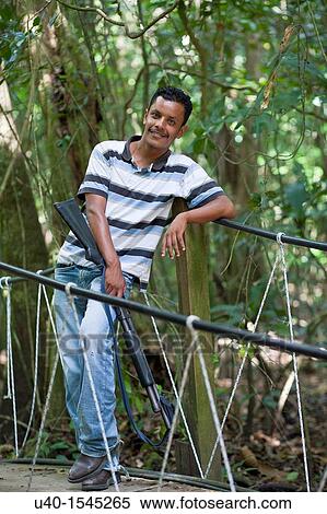 Stock Photography - Young man with shotgun. Fotosearch