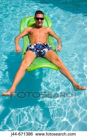 Young man with sunglasses on floating matress in the pool, Miramar, Florida, USA View Large Photo Image Stock Photograph - Young man with sunglasses on floating matress in the pool, Miramar, Florida, USA. Fotosearch