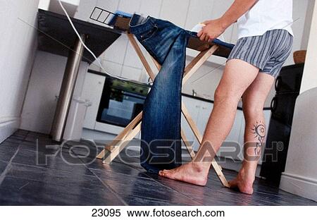 Young man with tattoo ironing his jeans View Large Photo Image Stock Photography - Young man with tattoo ironing his jeans. Fotosearch