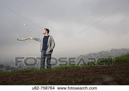Young man with tennis racket, San Francisco, California, USA View Large Photo Image Picture - Young man with tennis racket, San Francisco, California, USA. Fotosearch
