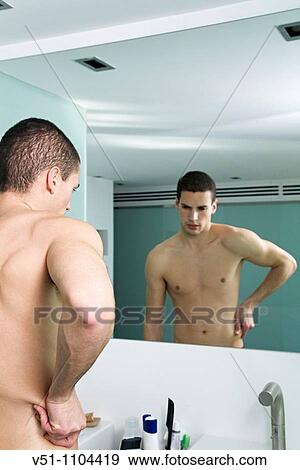 Stock Photo - Young man worried about the weight. Fotosearch
