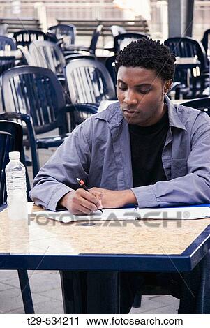 Young man writing View Large Photo Image Stock Image - Young man writing. Fotosearch