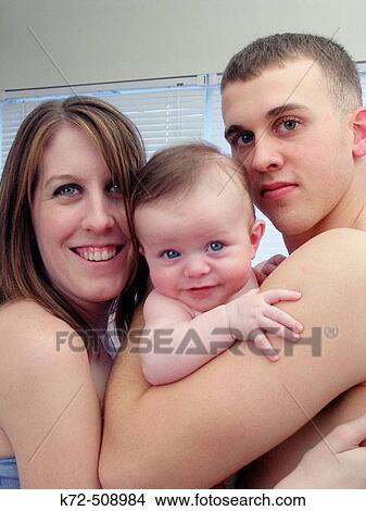 Young married couple with first child View Large Photo Image Picture - Young married couple with first child. Fotosearch