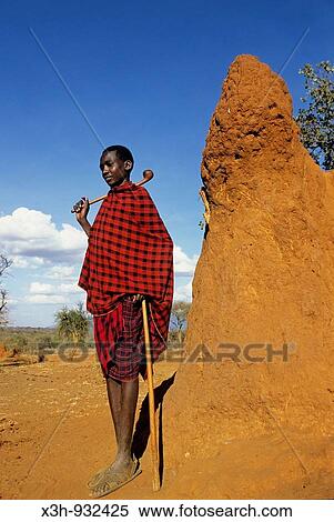 Young Masai man beside termite's mound, Kenya View Large Photo Image Stock Photography - Young Masai man beside termite's mound, Kenya. Fotosearch