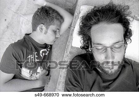 Young men sleeping on stairs View Large Photo Image Stock Image - Young men sleeping on stairs. Fotosearch
