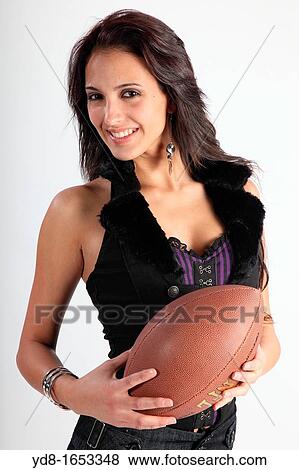 Stock Photo - young model posing with a ball at Studio futball. Fotosearch