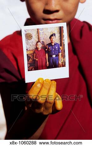 Young monk showing a Polaroid of him, Bhutan View Large Photo Image Stock Photo - Young monk showing a Polaroid of him, Bhutan. Fotosearch