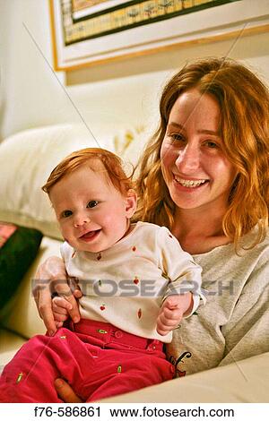 Young mother and 1 year old baby girl View Large Photo Image Stock Image - Young mother and 1 year old baby girl. Fotosearch