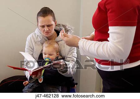 Young mother and child at the health visitors, looking concerned at the book View Large Photo Image Stock Photo - Young mother and child at the health visitors, looking concerned at the book. Fotosearch