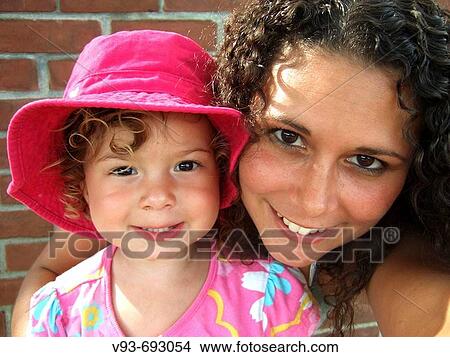 young mother and daughter in pink View Large Photo Image Picture - young mother and daughter in pink. Fotosearch