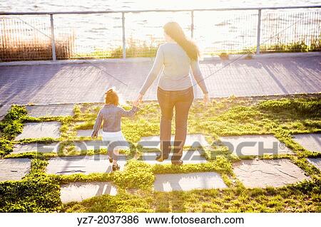 Stock Photograph - Young Mother and two year old daughter spending time together in the park.. Fotosearch