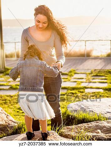 Young Mother and two year old daughter spending time together in the park, Sleepy Hollow. View Large Photo Image Stock Photography - Young Mother and two year old daughter spending time together in the park, Sleepy Hollow.. Fotosearch