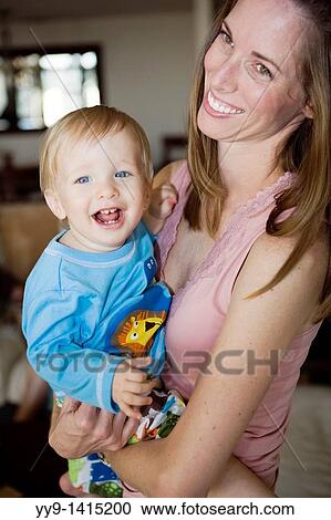 Stock Image - Young mother holding smiling baby boy - Fort Lauderdale, Florida USA. Fotosearch