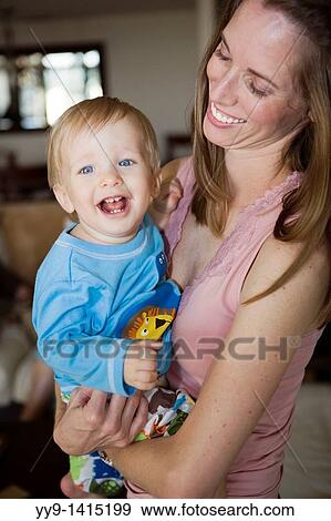Young mother holding smiling baby boy - Fort Lauderdale, Florida USA View Large Photo Image Stock Photo - Young mother holding smiling baby boy - Fort Lauderdale, Florida USA. Fotosearch
